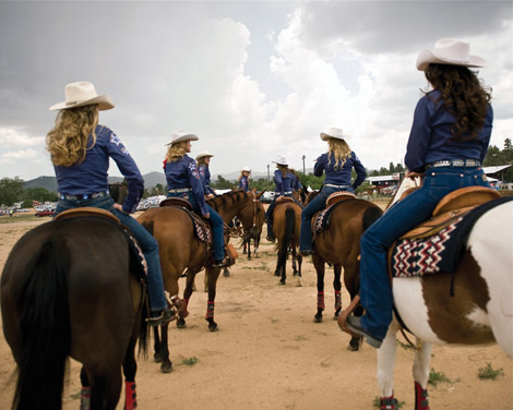 Cowgirls riding horses