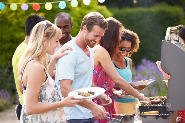 Group Of Friends Having Outdoor Barbeque At Home