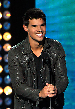 Actor Taylor Lautner speaks onstage.