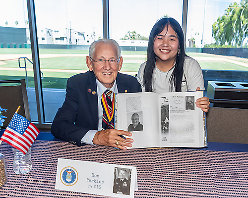 Ron Perkins and student holding book