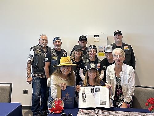 Veteran Tina Hasher surrounded by her American Legion peers
