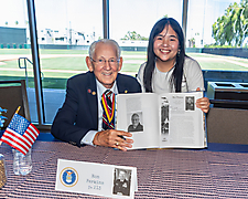 Ron Perkins and student holding book