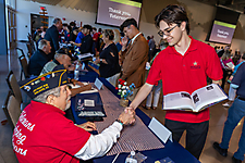 Student shaking vetearns hand