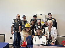 Veteran Tina Hasher surrounded by her American Legion peers
