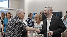 Past Board President Mike Burns shaking hands with current Board President Kerry Ahern