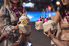 Attendees enjoy a coconut beverage