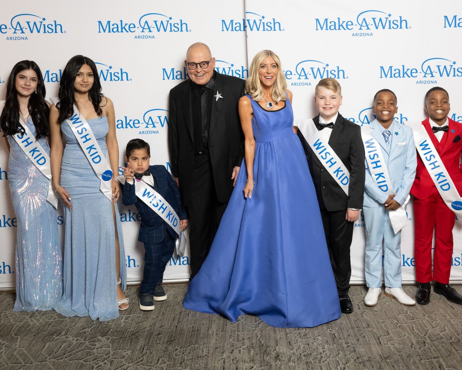 10. Bob and Renee Parsons with wish kids (From left emcee Mikaela Emery, Dennia Cazares, Zion Reza, Miles Boyd, and Jeremiyah and Elijah McKethan).jpg