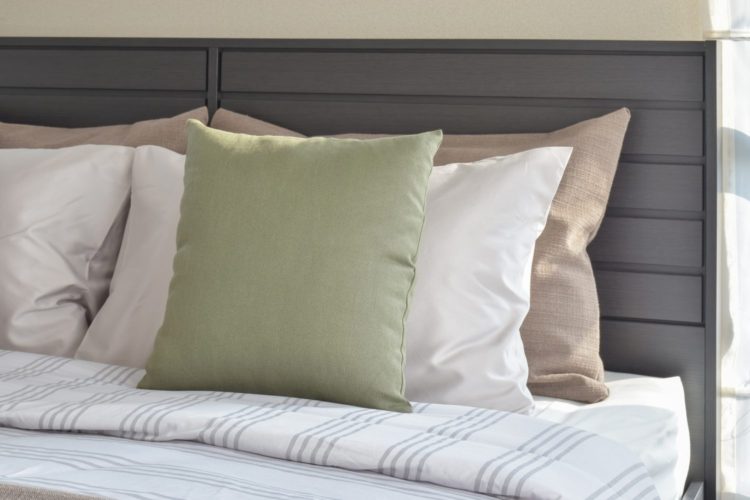 modern bedroom interior with green and white pillow on bed