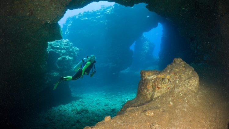 B659FX Diver at Caves of Lava Tubes Cathedrals of Lanai Maui Hawaii USA